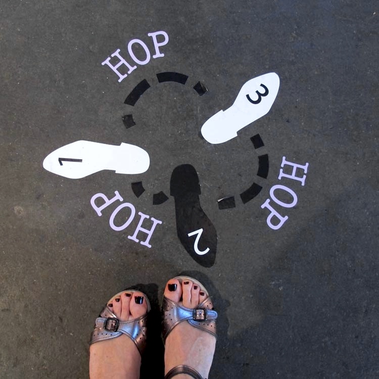 artist standing w floor piece 'hop'